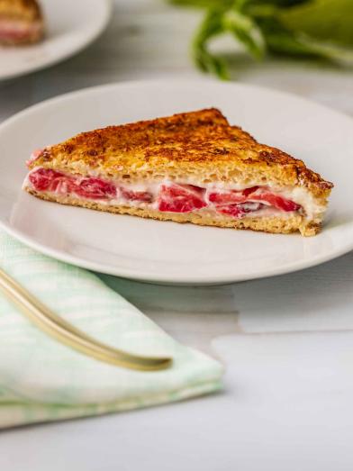 Stuffed strawberry French toast slice on white plate