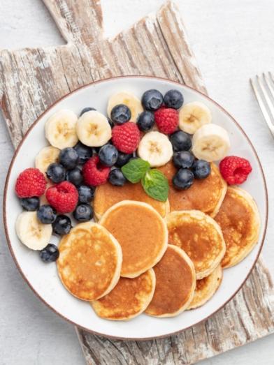 A plate of almond flour pancakes with berries