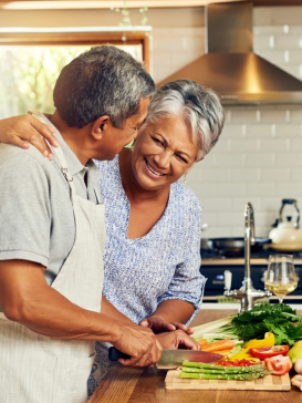 A Latinx couple cooking in the kitchen together