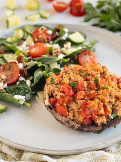A plate with a very low carb keto meal of turkey stuffed mushroom and salad for diabetes friendly eating