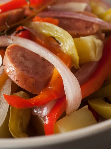 Sliced sausage, red &amp; white onions, bell peppers, potatoes, and thyme.