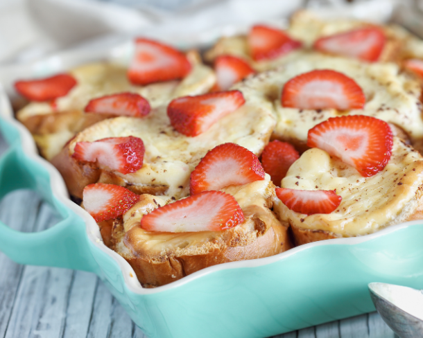 A blue casserole dish with strawberry french toast casserole