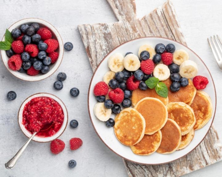 A plate of almond flour pancakes with berries