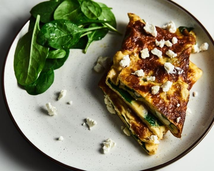 An omlete with spinach on a plate