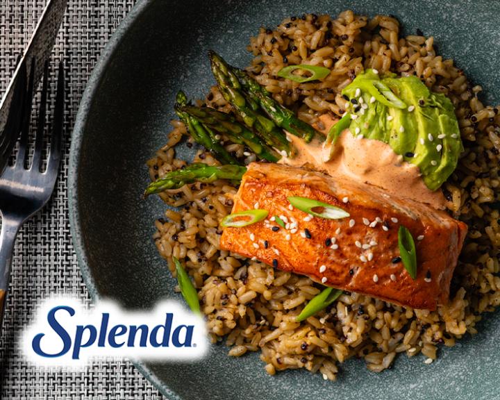 A plate of salmon, avocado, and veggies.