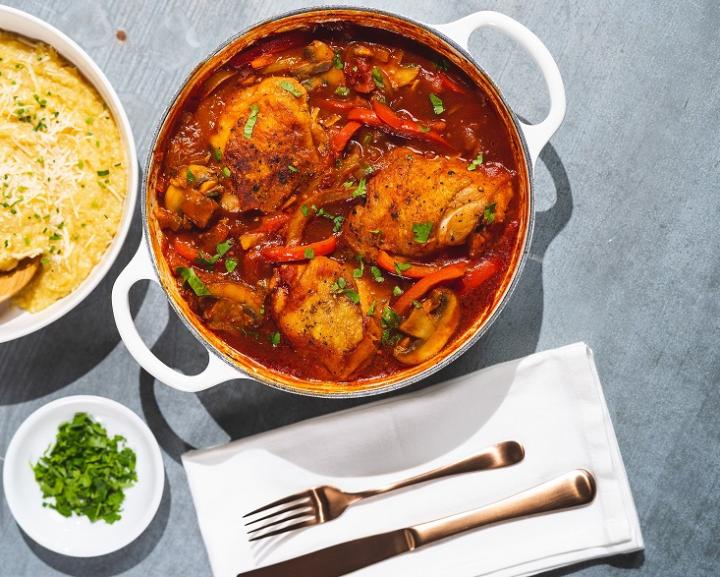 A bowl of several braised Moroccan chicken breasts