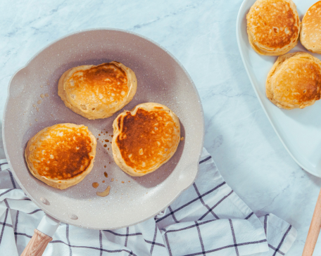 A pan with diabetes friendly sweet potato pancakes made with healthy whole wheat