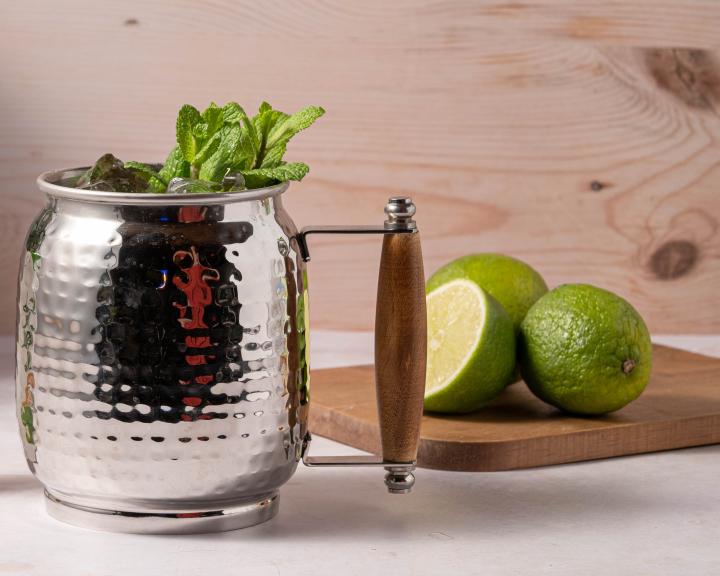 A diabetes friendly Moscow mule mocktail in a metal cup with limes