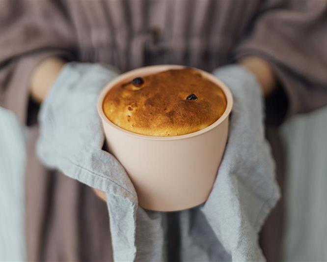 Person holding freshly baked cake