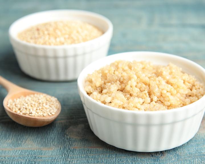 Cooked quinoa in small white bowl