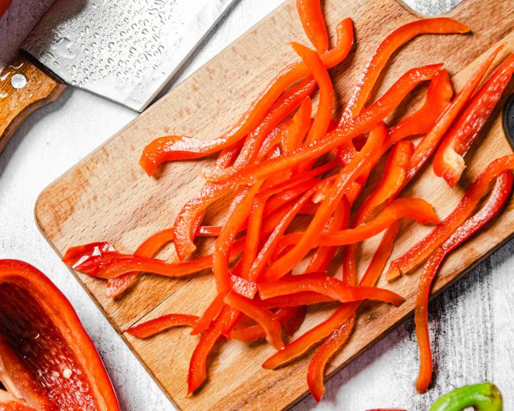 sliced red bell peppers on wooden cutting board