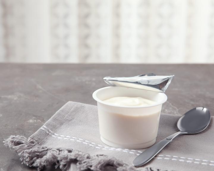 a container of soymilk yogurt on a napkin