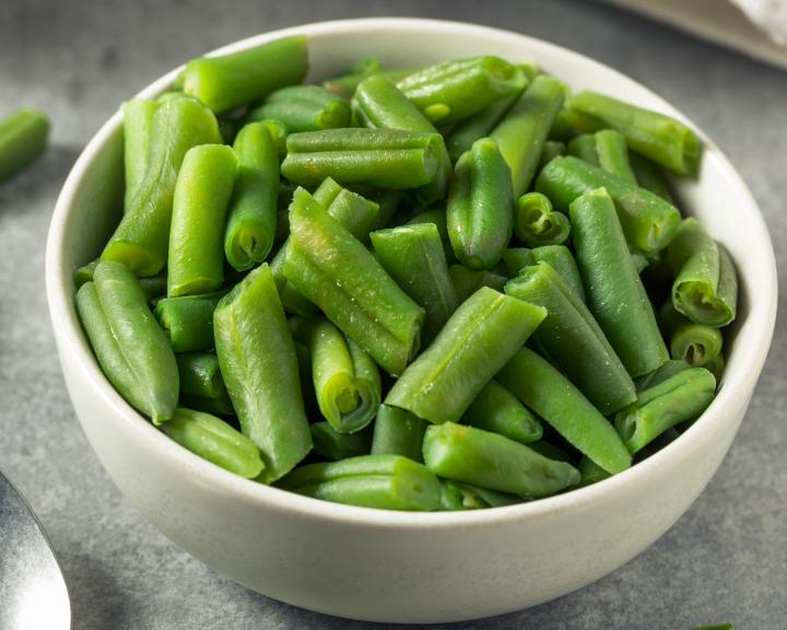 small white bowl containing steamed green beans