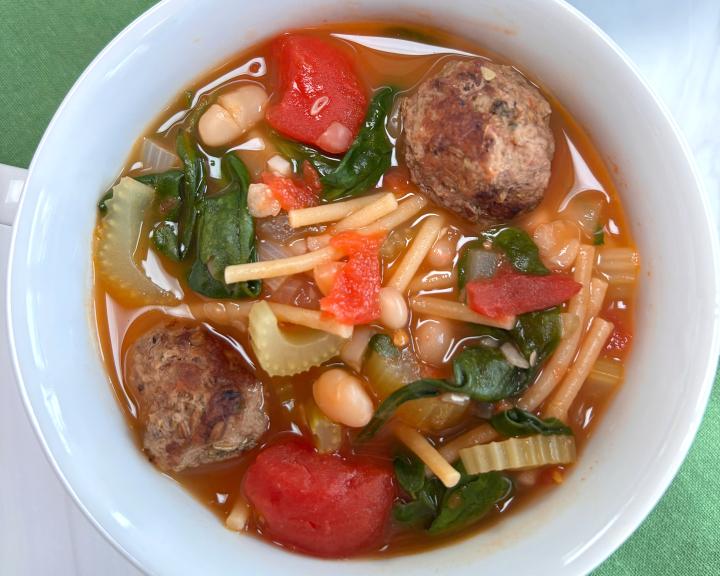 A bowl of meatball minestrone soup