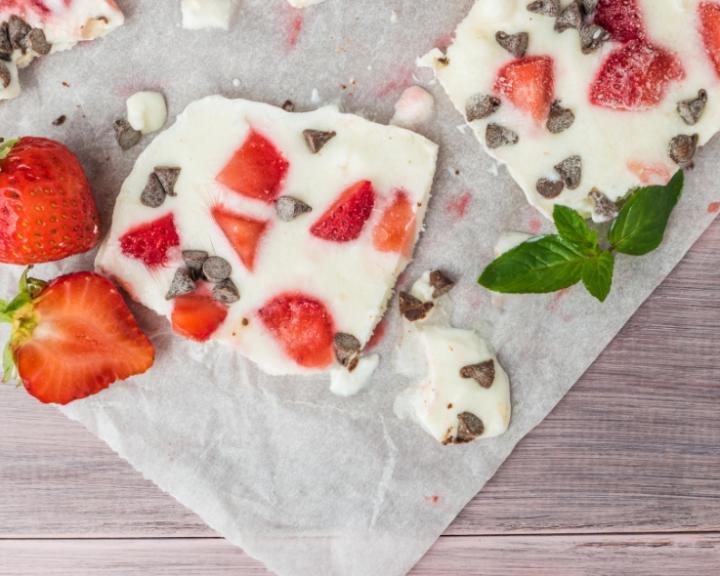 Frozen yogurt bark with strawberries, chocolate chips, and fresh mint.