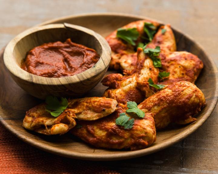 Lean chicken tenders coated in BBQ sauce, served with a dipping sauce.