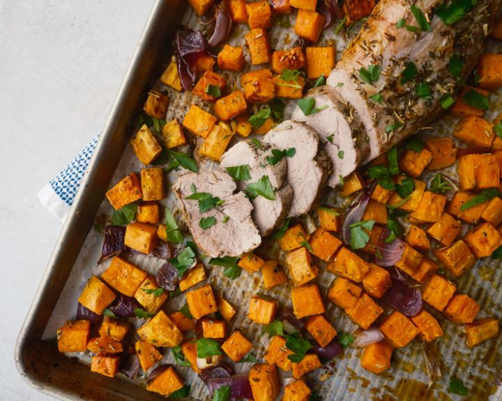 Sheet pan meal: sliced pork tenderloin, roasted sweet potatoes, and red onions.